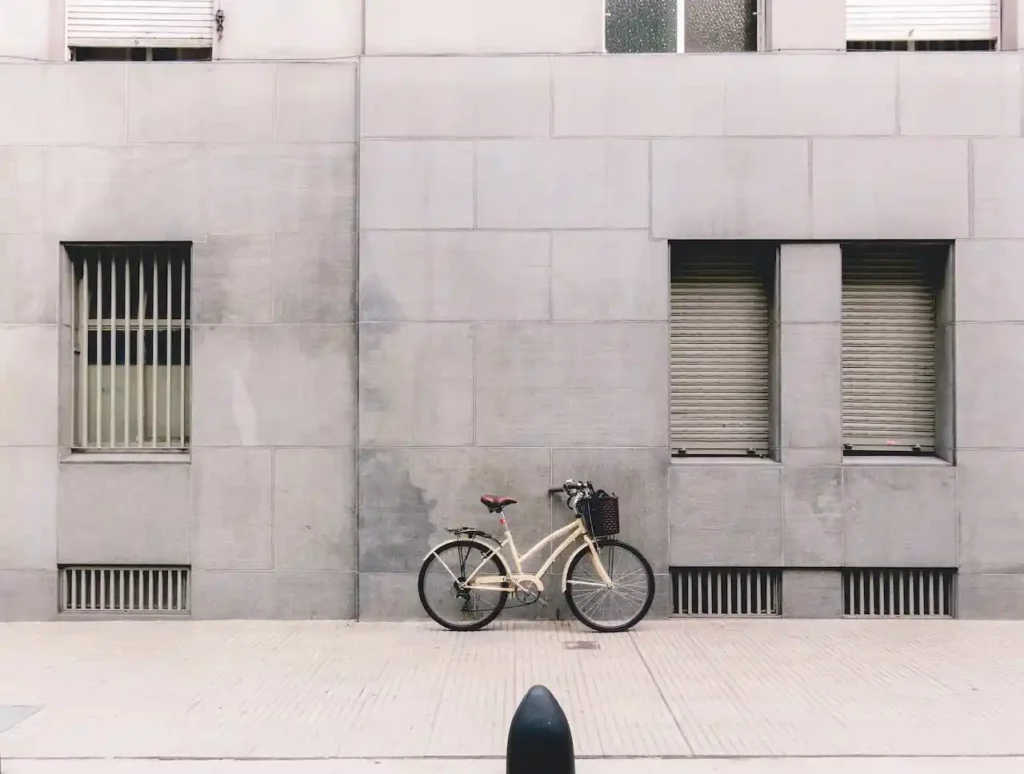 Bicycle parked against concrete building